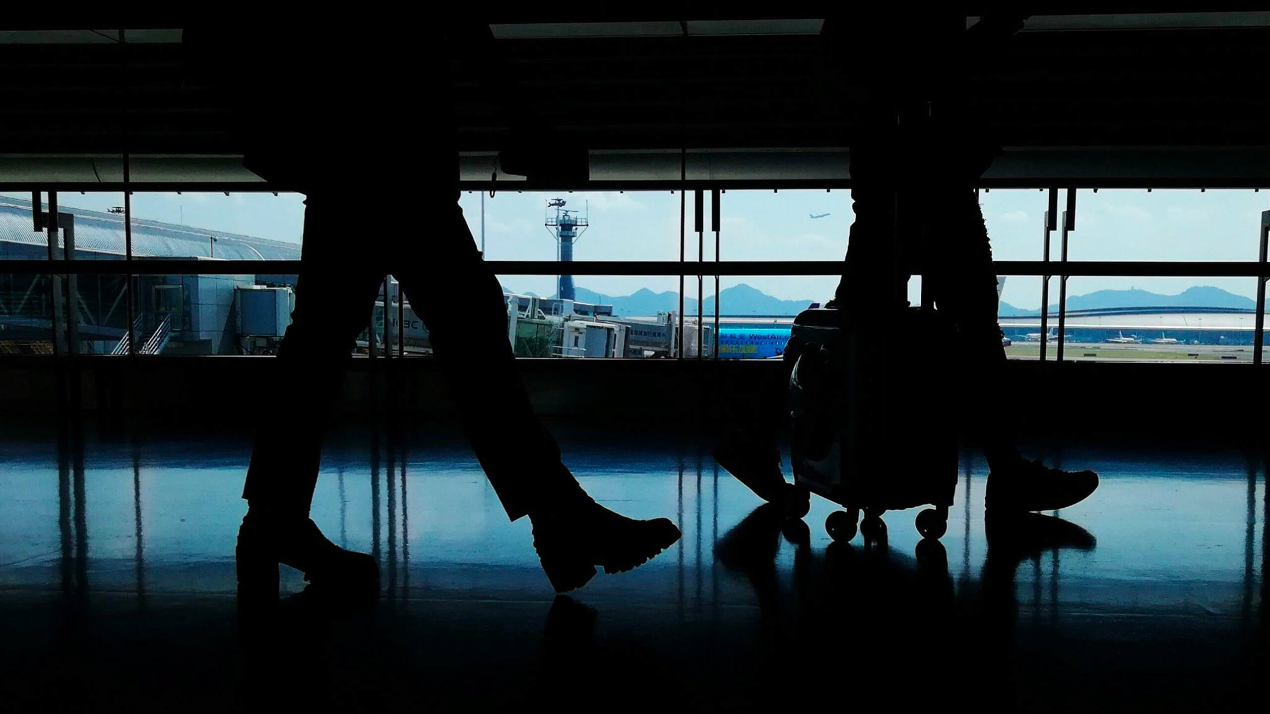 Travelers walking through an airport terminal