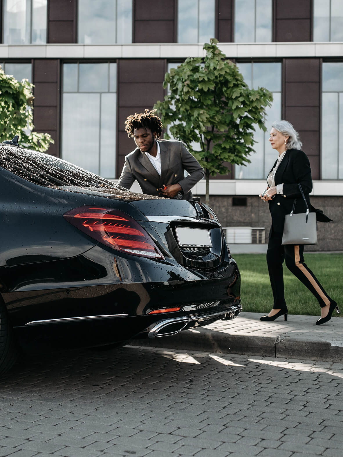 Chauffeur opening a car door for a guest